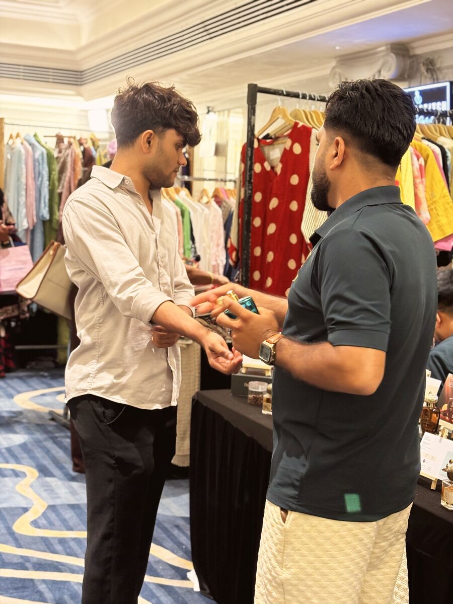 A vendor showing a bracelet to a shopper