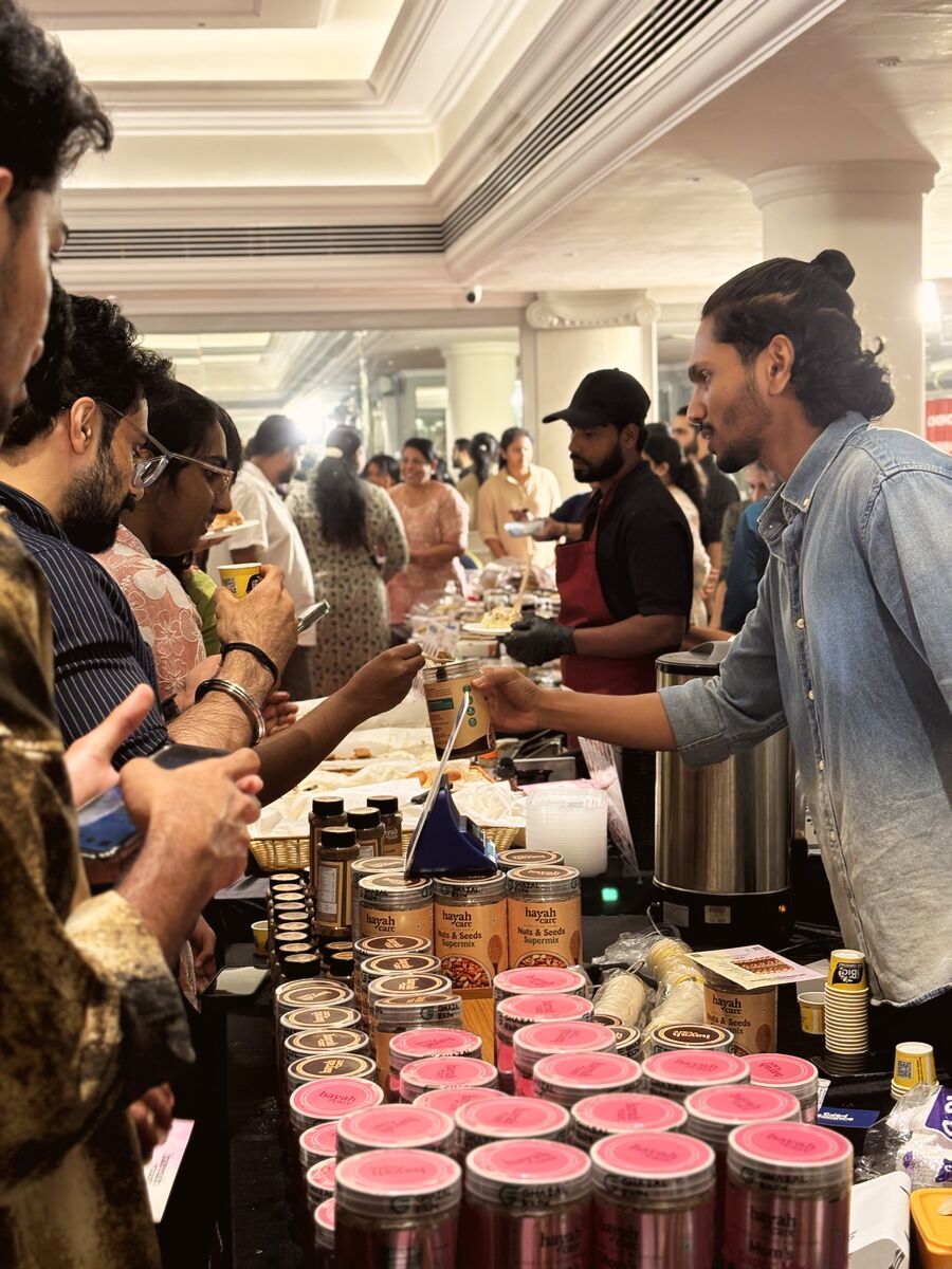 Visitors tasting from a long row of pink-lidded jars